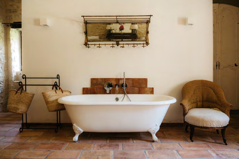 Freestanding bath in a stone guest room at Amassa