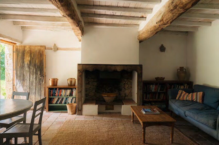 Whitewashed stone interior with original beams at Amassa