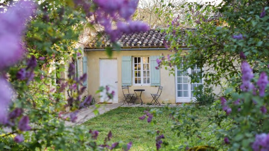Vine House at Amassa framed by flowering foliage